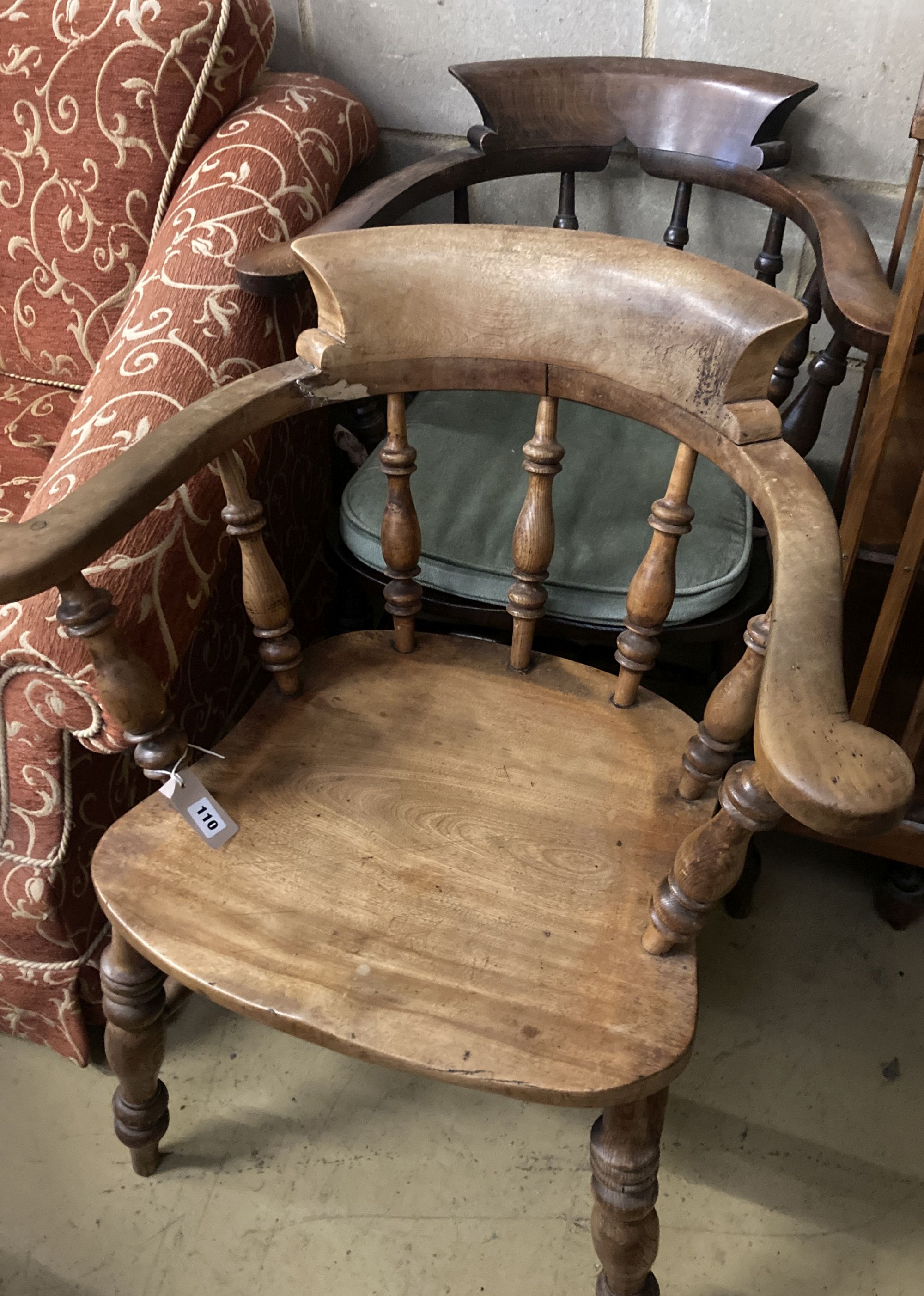 A Victorian smokers bow chair and a similar later chair.